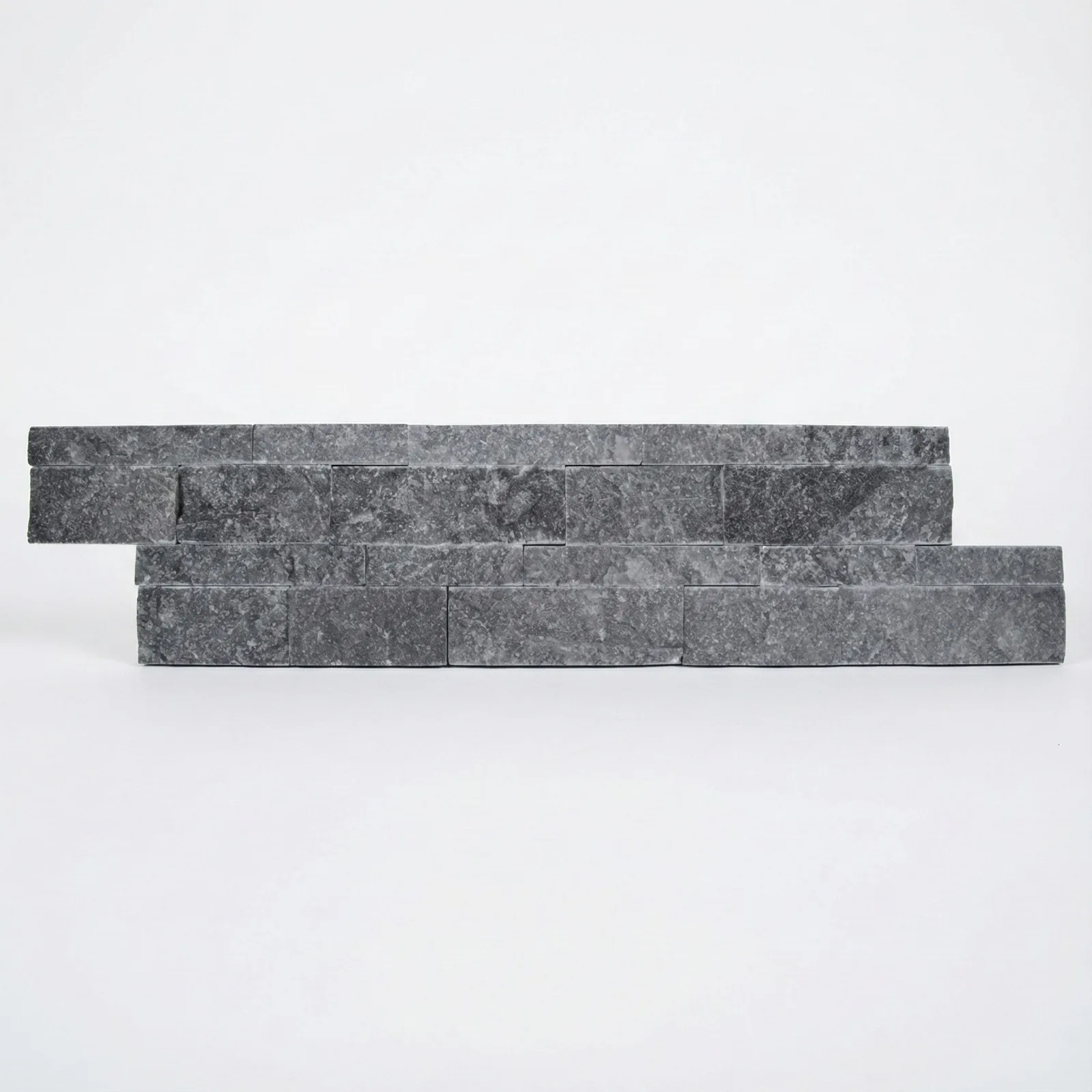 A black marble ledger panel photographed straight on, the charcoal faces broken by fine pale veining.