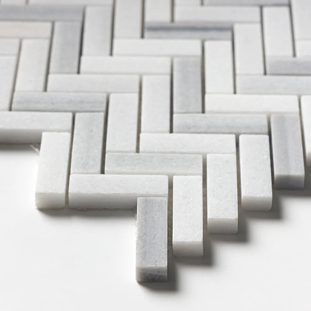Close detail of the Frost White herringbone, showing the sawn edges, the thickness of each baton and occasional soft grey veining.