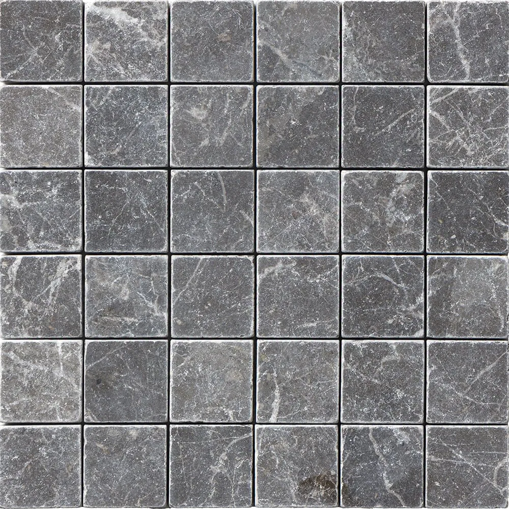 The Iris Black sheet straight on, thirty-six charcoal squares crossed by fine white veining, edges softened by tumbling.