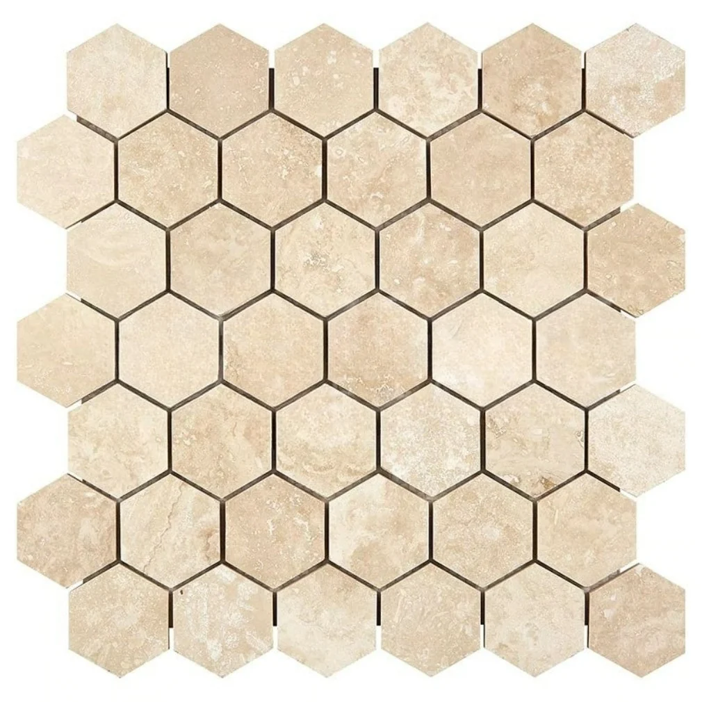 Two-inch travertine hexagons in warm cream, filled and honed so the surface reads smooth and closed rather than pitted.