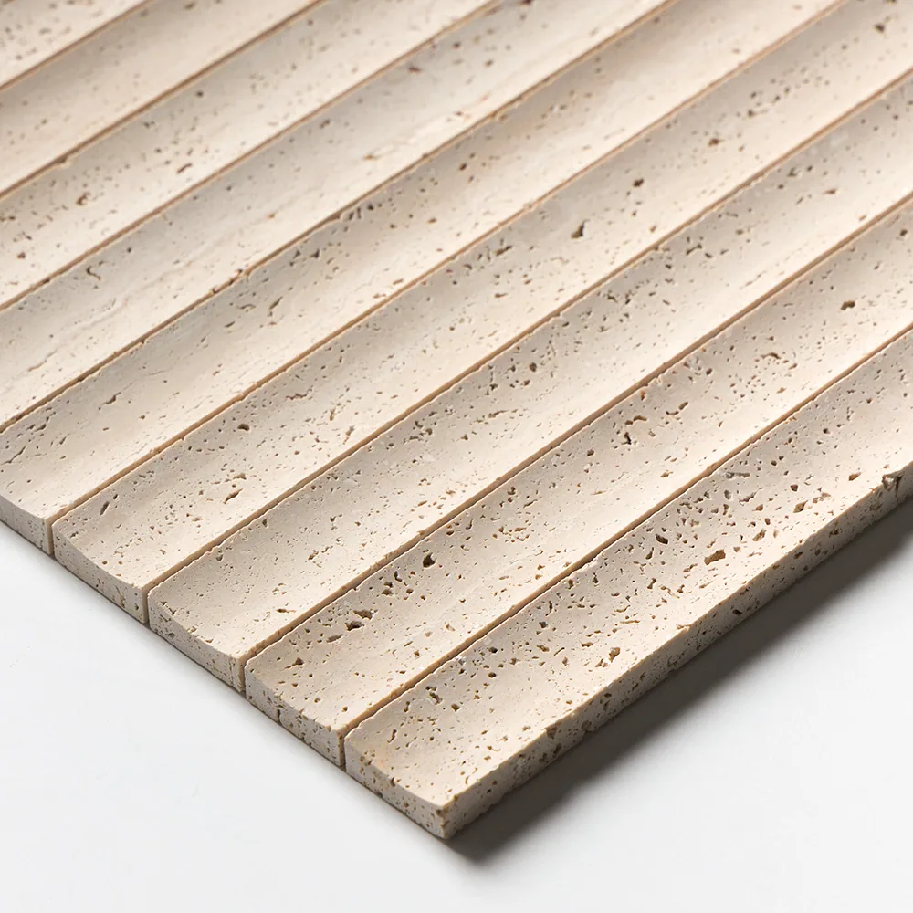 Close view of the fluted travertine, showing the rounded profile of each rib and the open unfilled pitting across the cream stone.