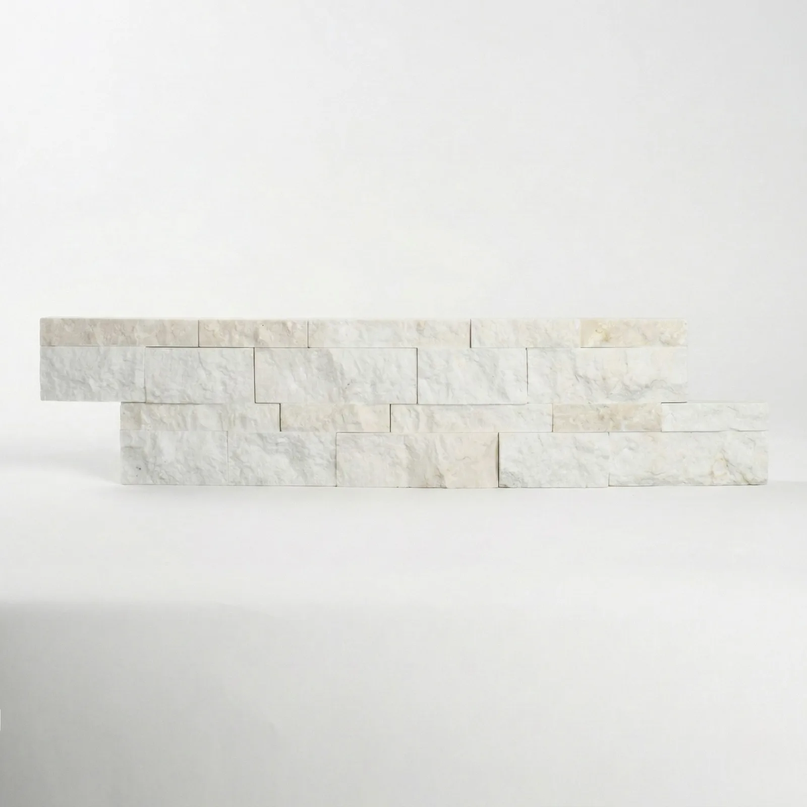 A limestone ledger panel photographed straight on, showing the even cream tone across its split face.