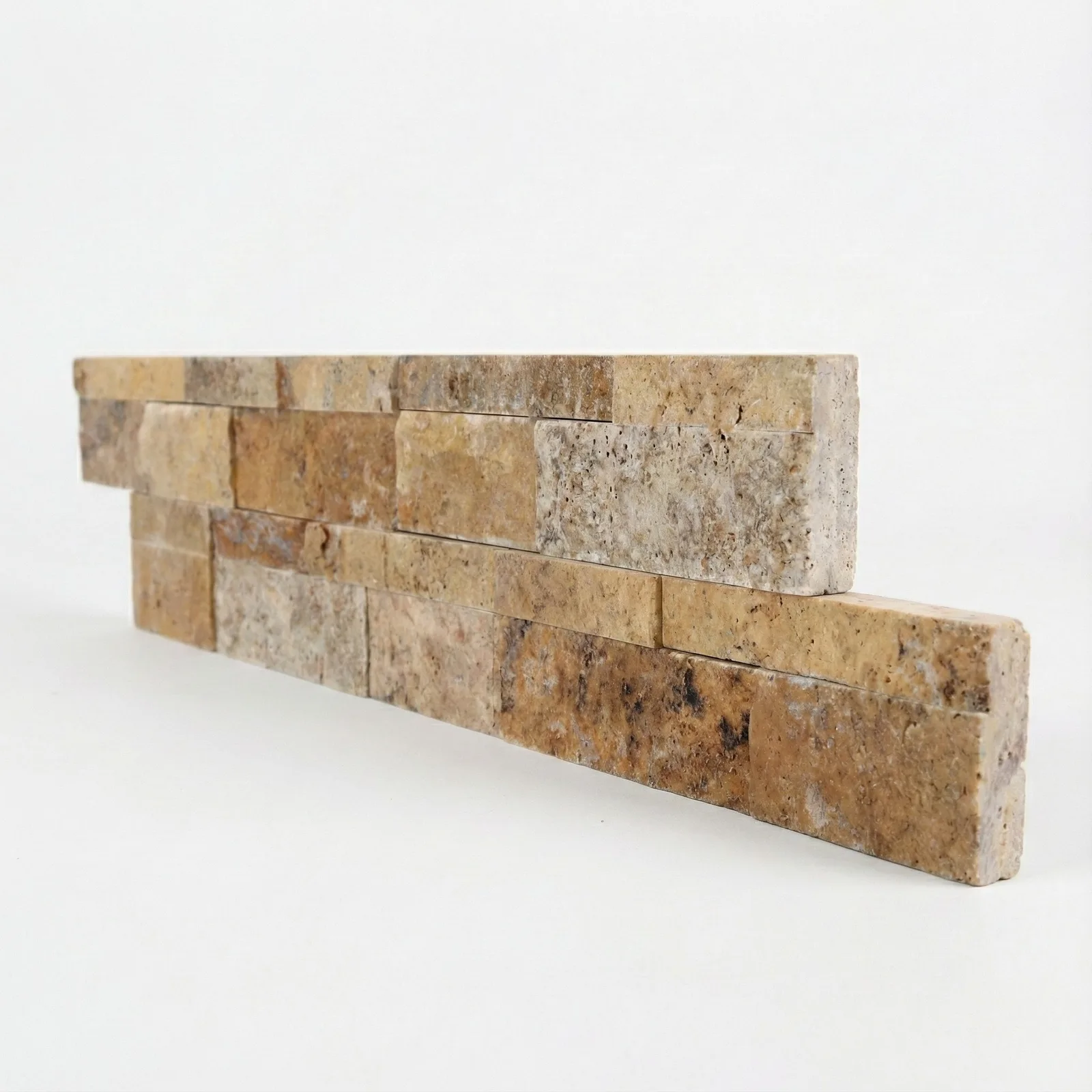 Scabos travertine ledger panel corner piece on a pale studio ground: two offset courses running through rust, gold, walnut and cream, the warmest of the travertine panels.
