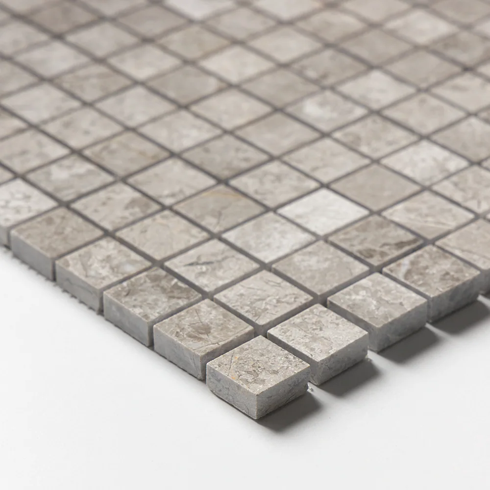 Corner detail of the polished Silver Clouds sheet, the grey squares catching light along their cut edges.