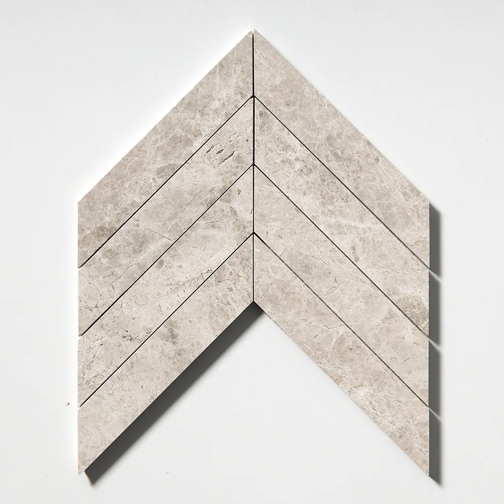 The chevron seen straight on, broad pale grey planks meeting at a precise point to form a single arrow.
