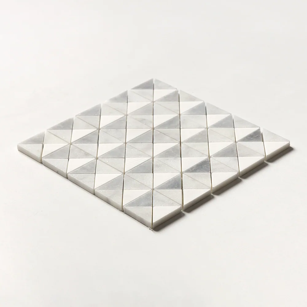 Devon pattern marble mosaic angled on white, its triangular chips faceted so the sheet reads as a field of low pyramids in white and pale grey.