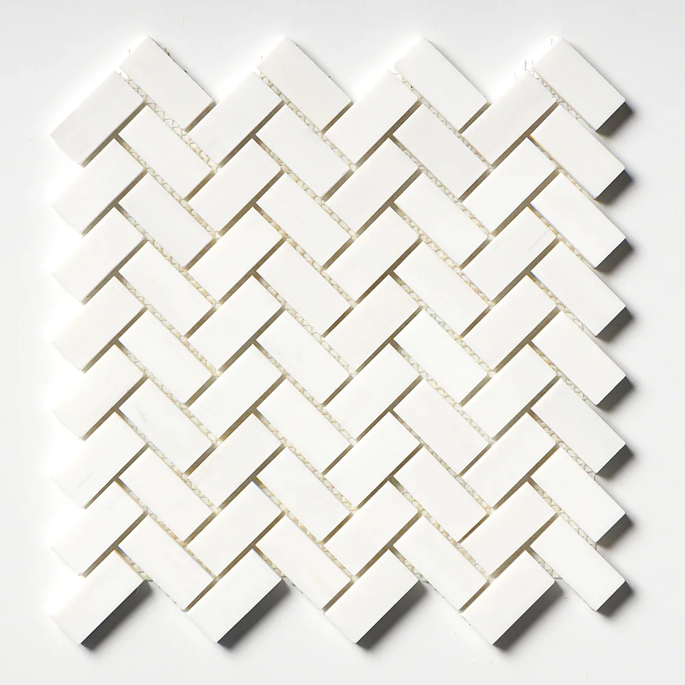 The polished Snow White herringbone straight on, an even weave of bright white chips with narrow pale grout lines.