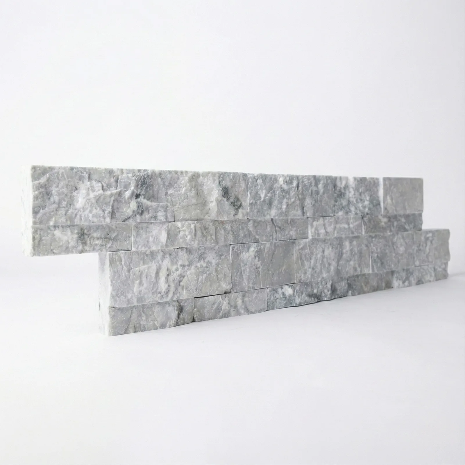 A Tundra Grey marble ledger panel photographed straight on, showing the grey and chalk-white banding along its split face.
