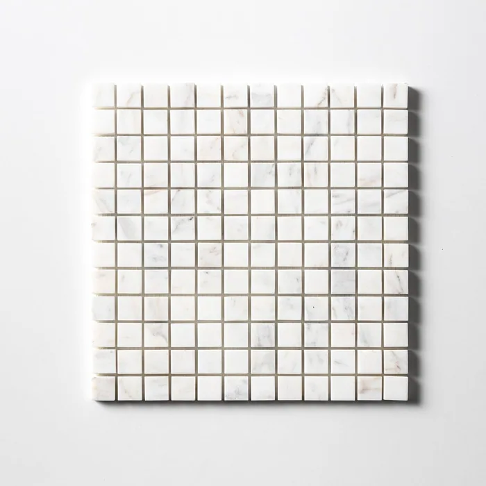 Calacatta Gold mosaic of one-inch squares seen straight on, predominantly white with occasional chips carrying grey and warm gold veining.