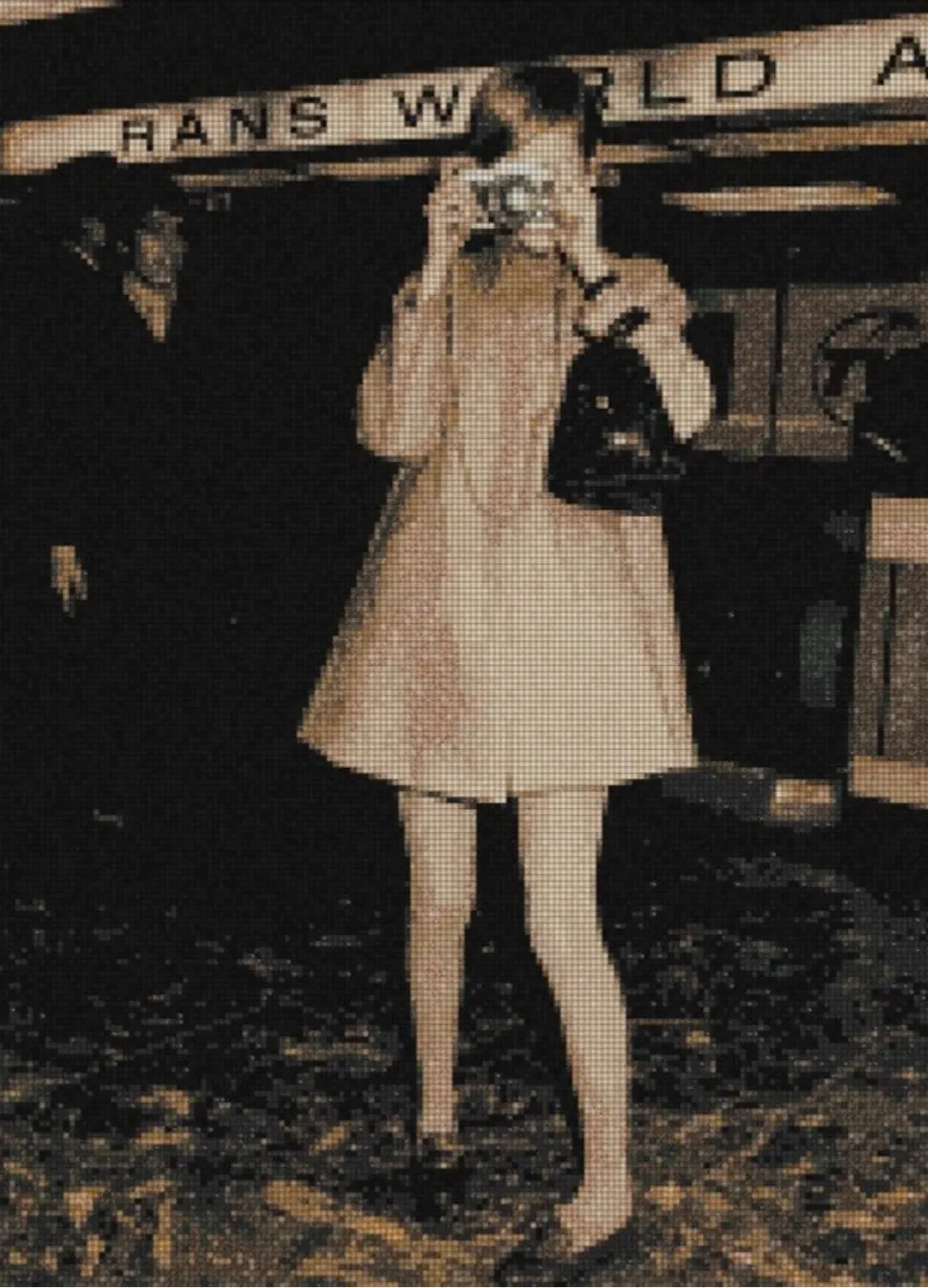 Say Cheese as a mosaic simulation: a woman in a pale coat raising a camera to her eye beneath an airline terminal sign, rendered in warm greys and sepia tesserae.