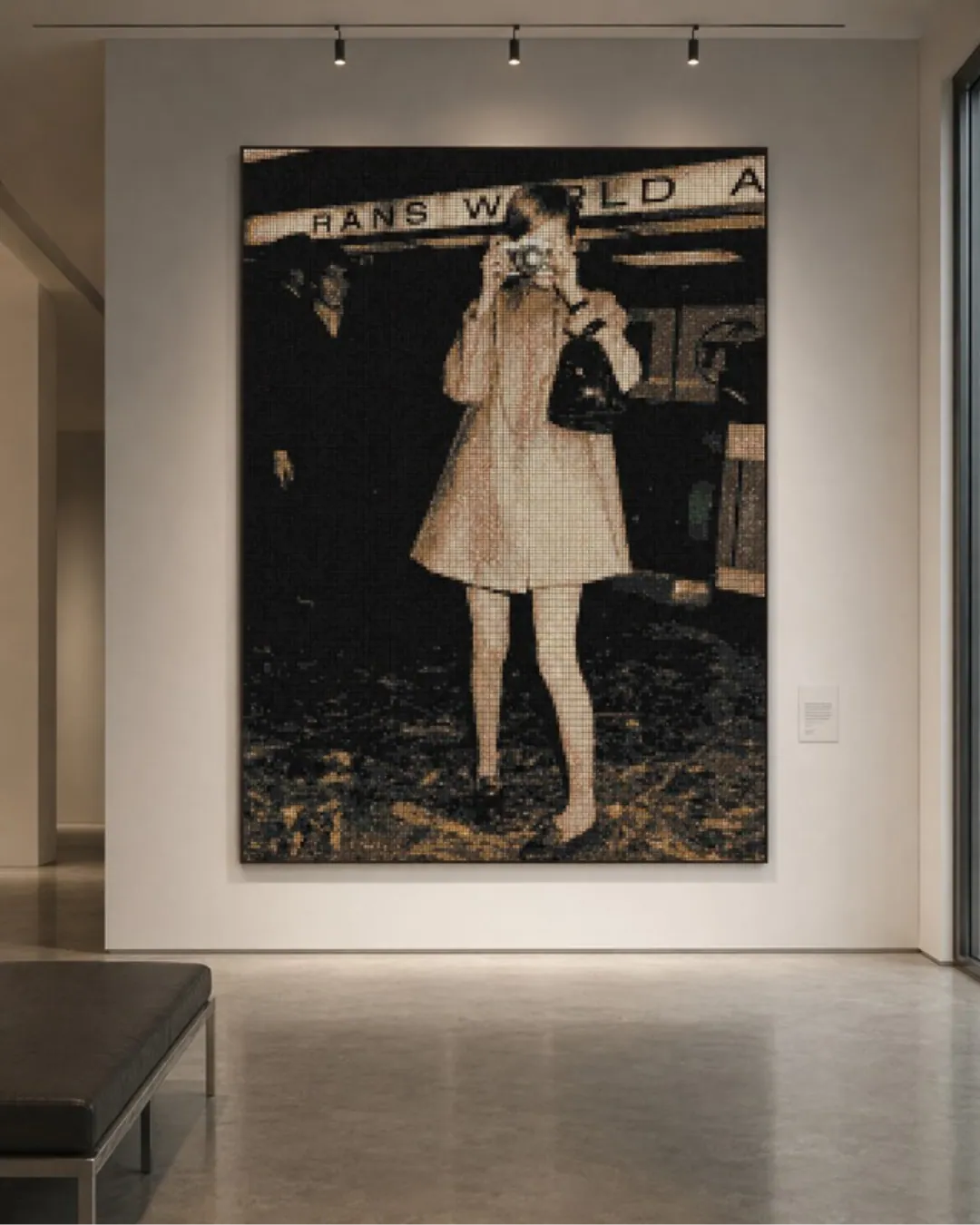 A simulation of the same artwork hung as a large framed panel in a pale gallery interior, a low bench in front of it.